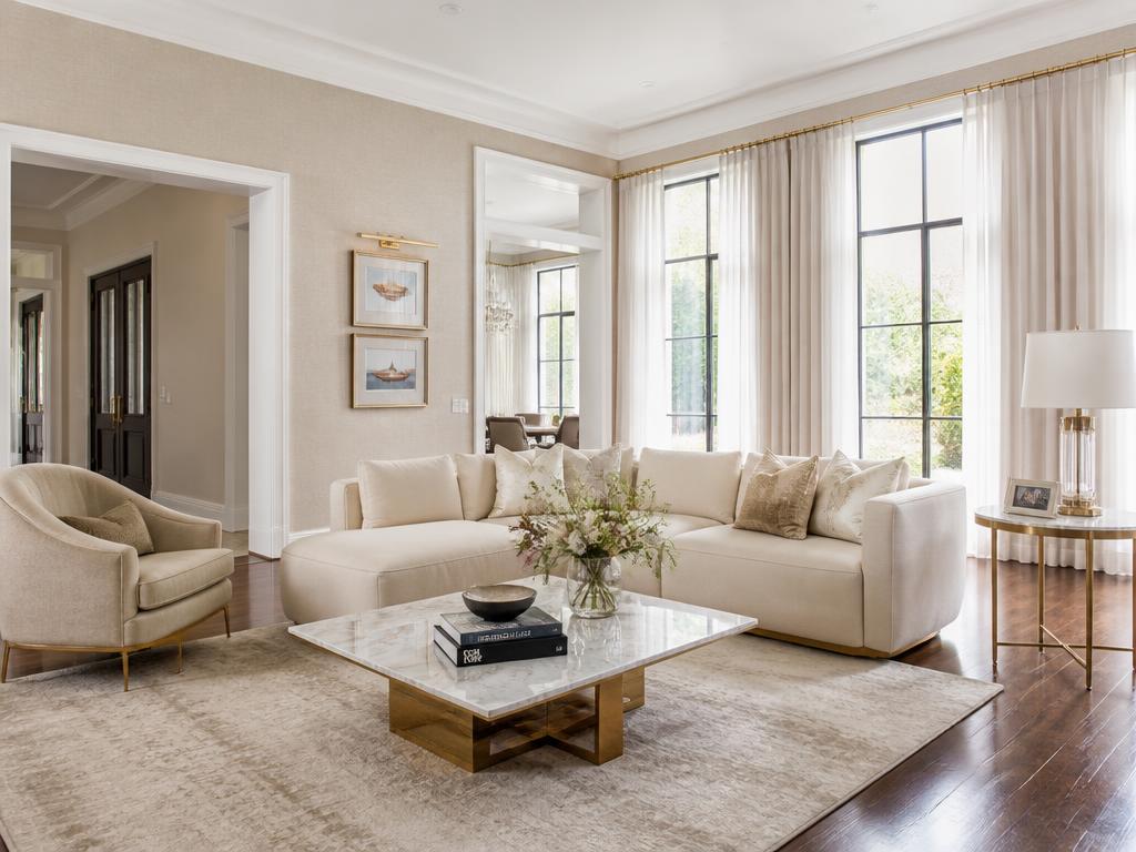 Bright, luxurious living room with elegant furnishings and pristine finishes